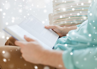 Image showing close up of man reading book at home