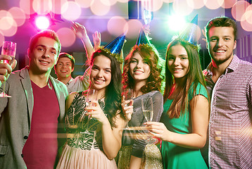 Image showing smiling friends with glasses of champagne in club