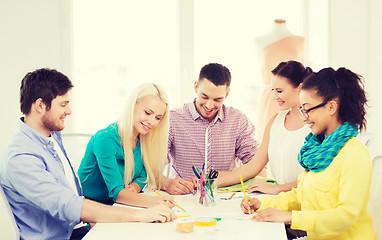 Image showing smiling fashion designers working in office