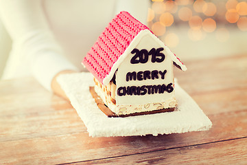 Image showing close up of woman showing gingerbread house