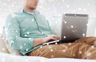 Image showing close up of man working with laptop at home