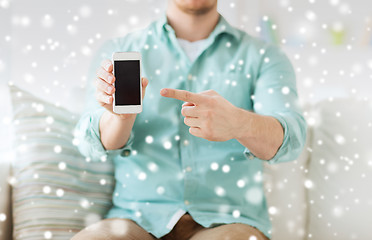 Image showing close up of man showing smartphone at home