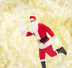 Image showing man in costume of santa claus with clock