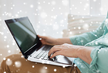 Image showing close up of man working with laptop at home