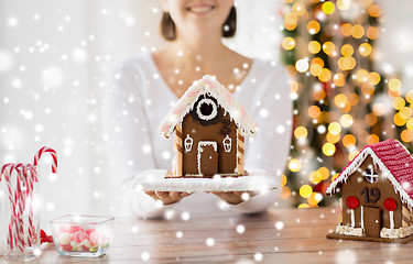 Image showing close up of woman showing gingerbread house