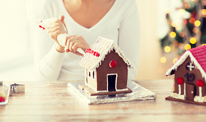 Image showing close up of woman making gingerbread houses