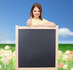 Image showing happy little girl with blank blackboard