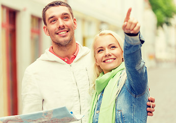 Image showing happy couple with map exploring city