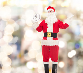 Image showing man in costume of santa claus with clock