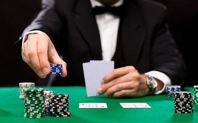 Image showing poker player with cards and chips at casino