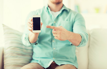 Image showing close up of man sitting with smartphone at home