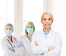 Image showing smiling female doctor with group of medics