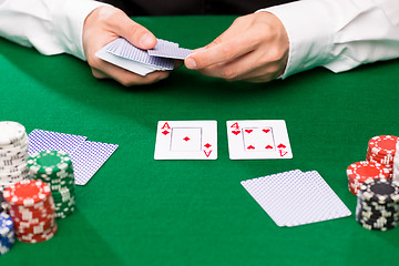 Image showing holdem dealer with playing cards and casino chips