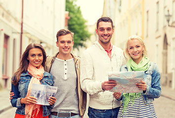 Image showing group of smiling friends with city guide and map