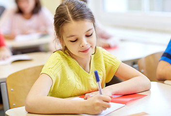 Image showing group of school kids writing test in classroom