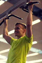 Image showing smiling man exercising in gym