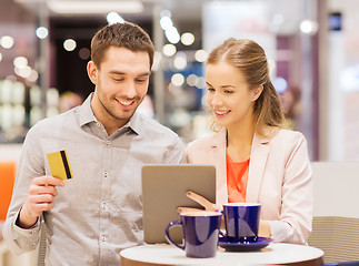 Image showing couple with tablet pc and credit card in mall