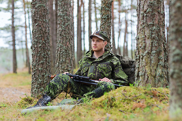 Image showing young soldier or hunter with gun in forest