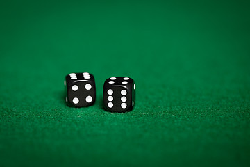 Image showing close up of black dice on green casino table