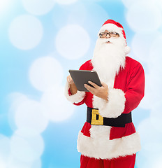 Image showing man in costume of santa claus with tablet pc