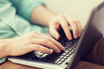 Image showing close up of man working with laptop at home