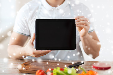 Image showing closeup of man showing tablet pc screen in kitchen