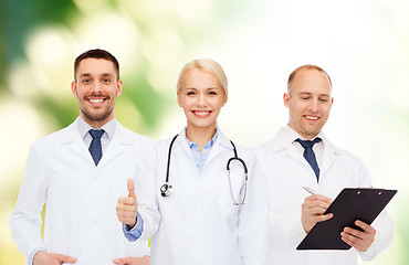 Image showing group of doctors showing thumbs up over white
