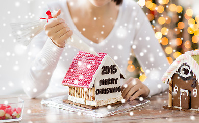 Image showing close up of woman making gingerbread houses