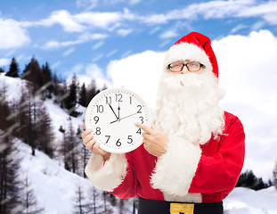 Image showing man in costume of santa claus with clock