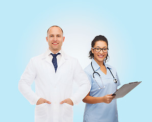 Image showing smiling doctors with clipboard and stethoscopes