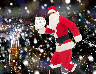 Image showing man in costume of santa claus with clock