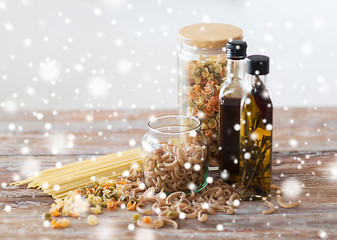 Image showing close up of olive oil bottles and pasta in jars