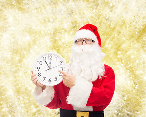 Image showing man in costume of santa claus with clock