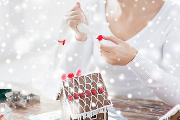 Image showing close up of woman making gingerbread houses