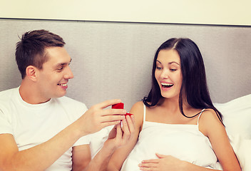 Image showing man giving woman little red box and ring in it