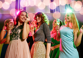 Image showing smiling friends with glasses of champagne in club