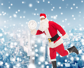 Image showing man in costume of santa claus with clock