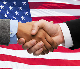 Image showing close up of handshake over american flag