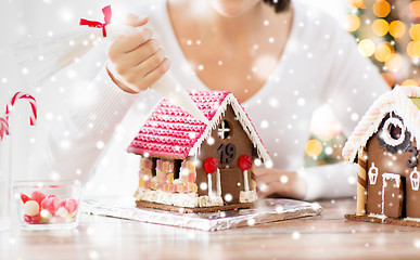 Image showing close up of woman making gingerbread houses