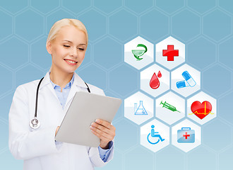 Image showing smiling doctor with tablet pc and medical symbols