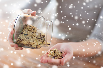 Image showing female emptying jar with white and wild black rice