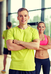 Image showing smiling man and woman in gym