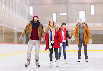 Image showing happy friends on skating rink
