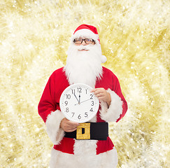 Image showing man in costume of santa claus with clock