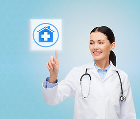 Image showing smiling doctor or nurse pointing to pills icon