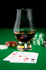 Image showing close up of chips, cards and whisky glass on table