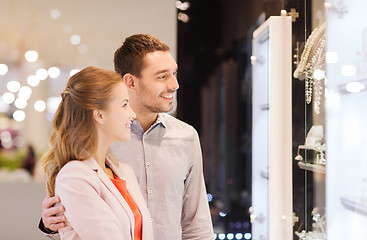 Image showing couple looking to shopping window at jewelry store