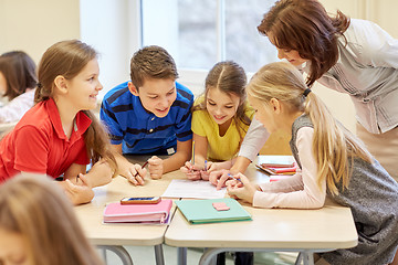 Image showing group of school kids writing test in classroom