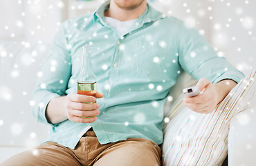 Image showing man with beer and remote control at home