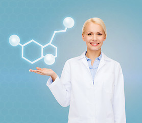 Image showing smiling female doctor pointing to molecule